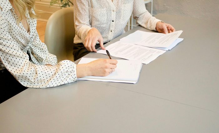 Home seller signing a real estate contract